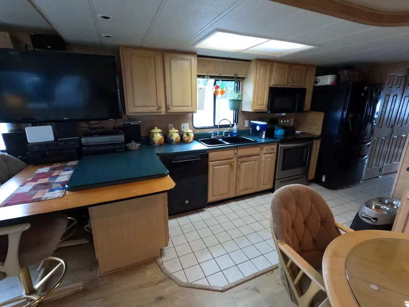 Slide: The Image of Kitchen interior of 1998 Jamestowner 1667WB Americana Custom houseboat with modern appliances. - 36