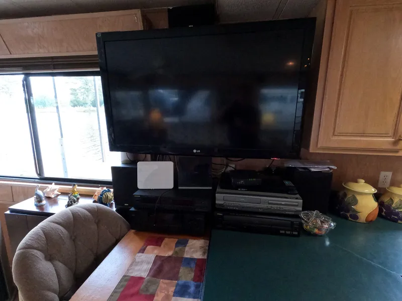 Slide: The Image of 1998 Jamestowner 1667WB Americana Custom interior with TV and entertainment setup. - 38