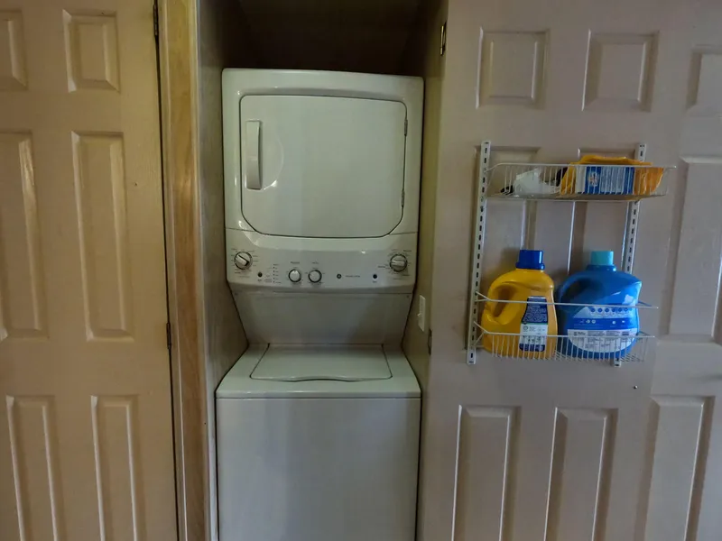 Slide: The Image of Stacked washer and dryer in a compact laundry closet with detergent shelf. - 43