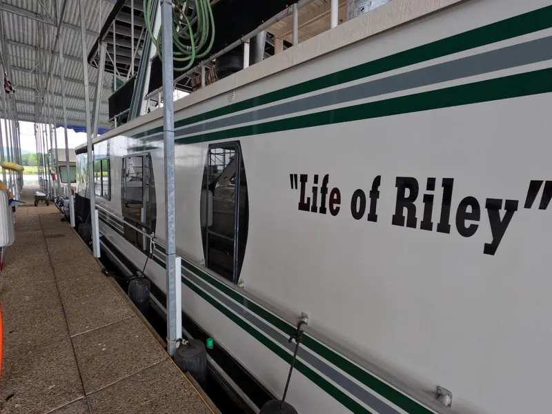 Slide: The Image of 1998 Jamestowner 1667WB Americana Custom houseboat named "Life of Riley" docked in a marina. - 6