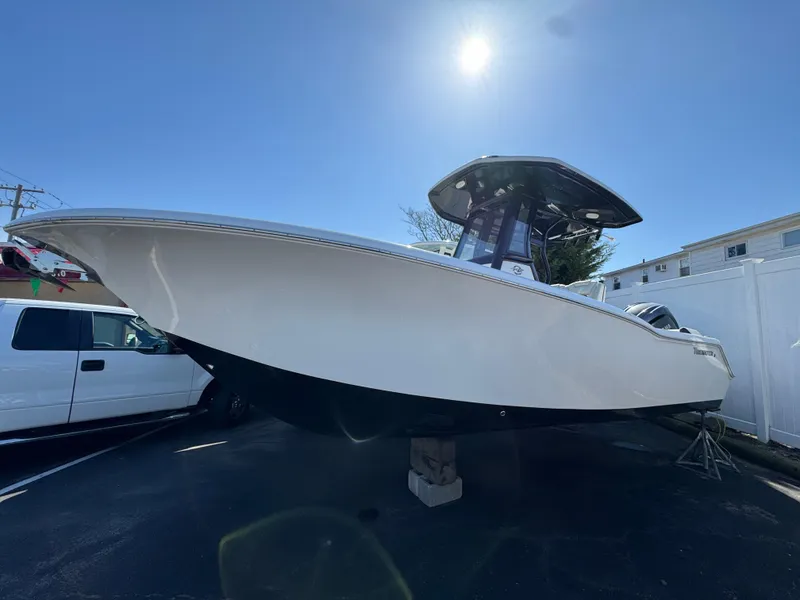 Slide: The Image of 2025 Tidewater 232 LXF boat displayed outdoors under clear blue sky. - 1