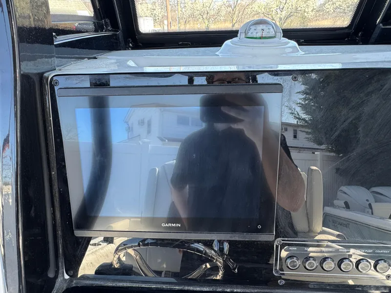 Slide: The Image of 2025 Tidewater 232 LXF boat dashboard with Garmin display and control panel. - 10