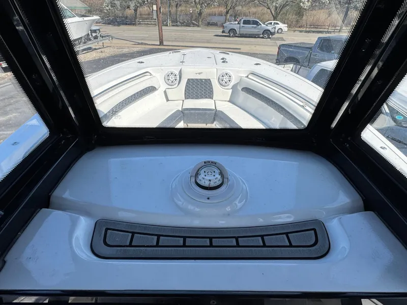Slide: The Image of 2025 Tidewater 232 LXF boat interior with dashboard and windshield view. - 12