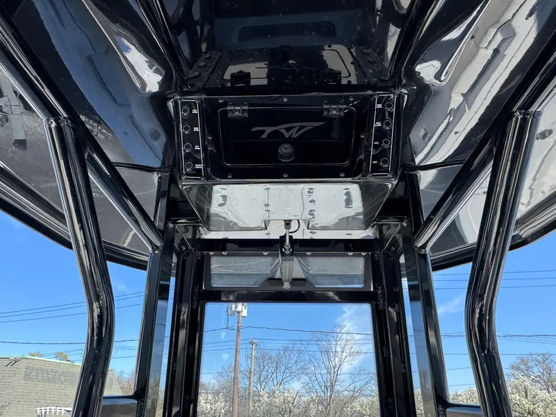 Slide: The Image of 2025 Tidewater 232 LXF boat interior with sleek black framework and clear sky view. - 13
