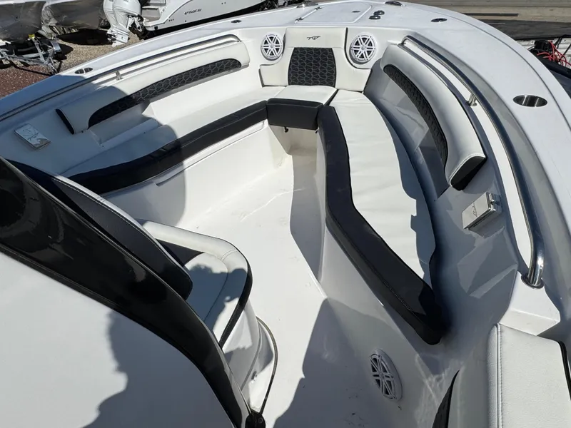 Slide: The Image of 2025 Tidewater 232 LXF boat interior with seating and speakers. - 18