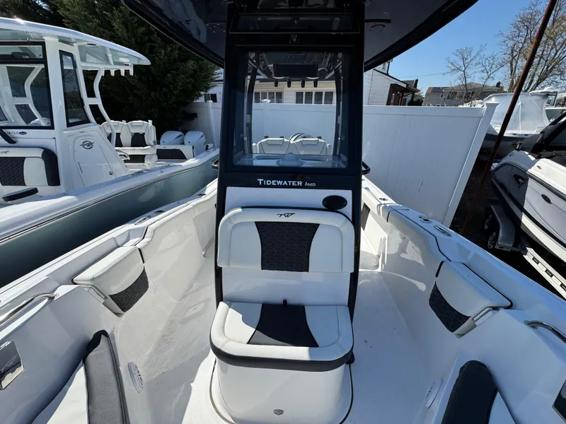 Slide: The Image of 2025 Tidewater 232 LXF boat interior with seating and console, showcasing modern design. - 22