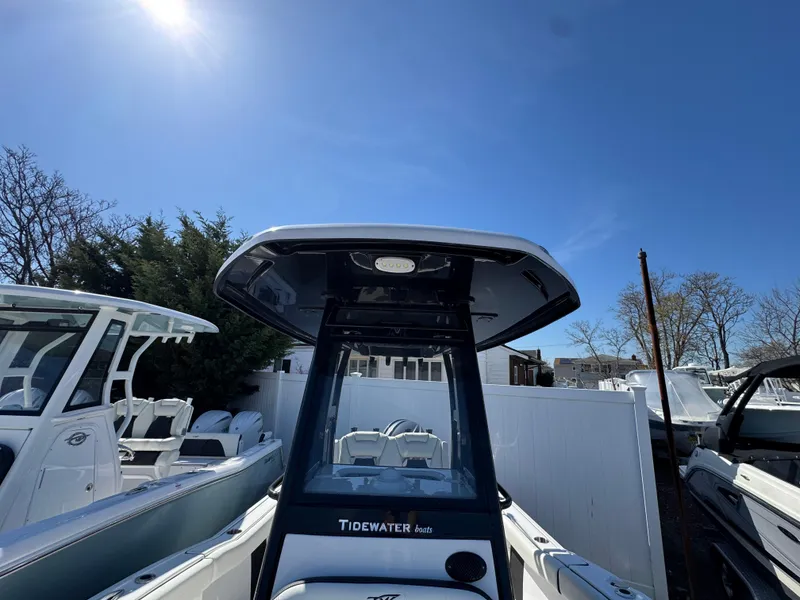 Slide: The Image of 2025 Tidewater 232 LXF boat under clear blue sky, showcasing sleek design and modern features. - 23