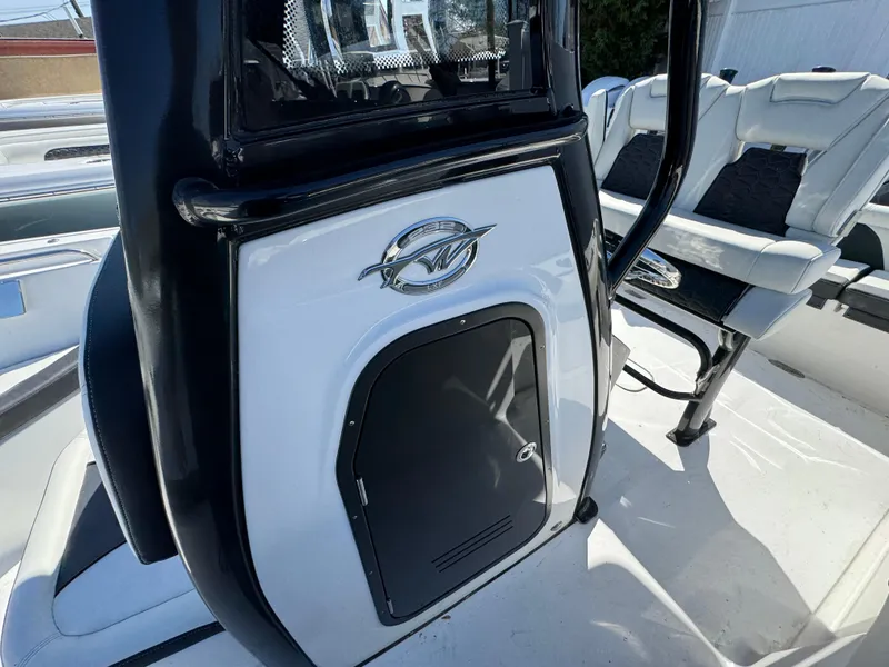 Slide: The Image of 2025 Tidewater 232 LXF boat interior with seating and storage compartment. - 24