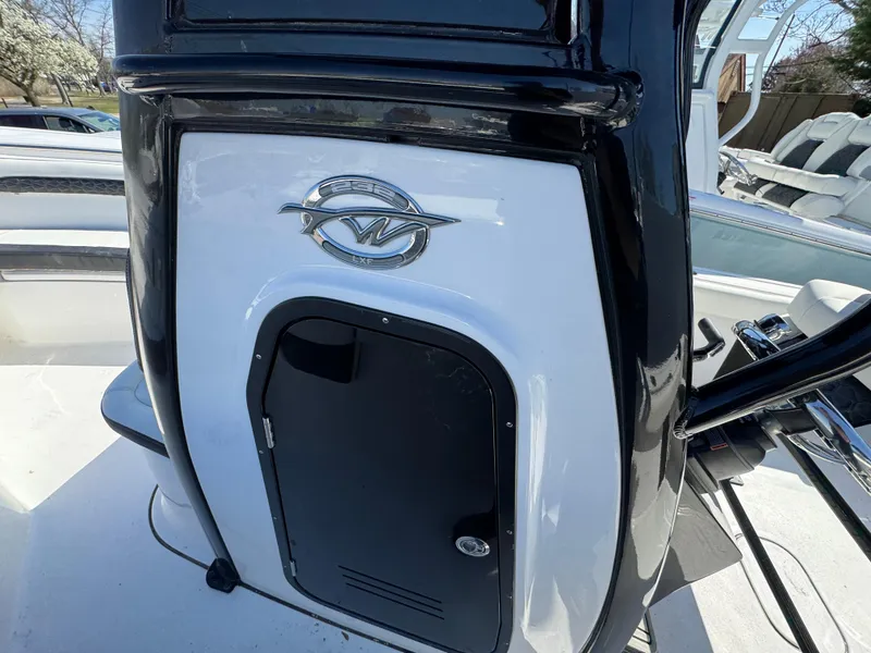Slide: The Image of 2025 Tidewater 232 LXF boat console with sleek black and white design. - 26