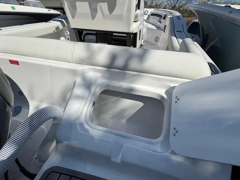 Slide: The Image of 2025 Tidewater 232 LXF boat interior with seating and storage compartment. - 3