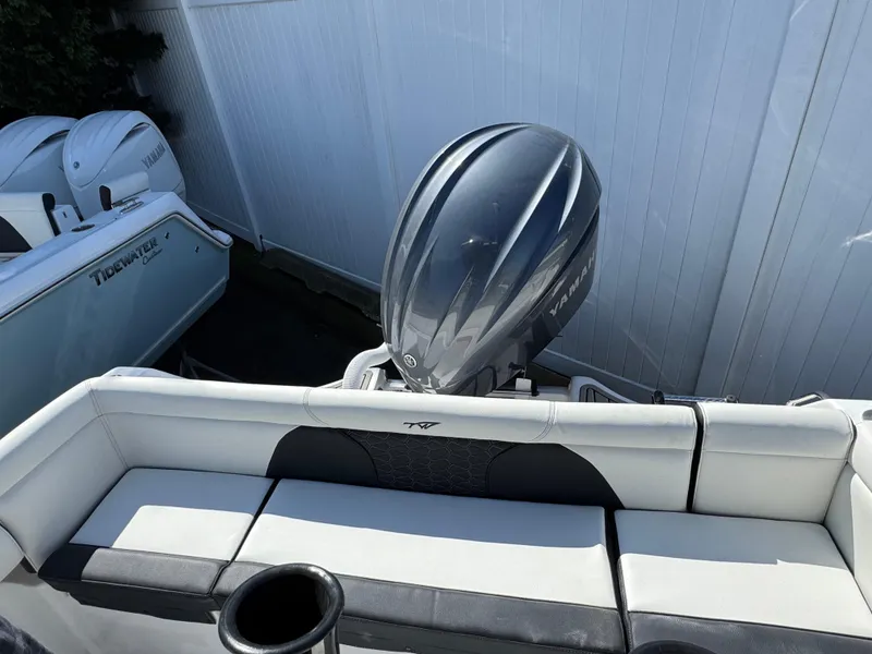 Slide: The Image of 2025 Tidewater 232 LXF boat with sleek outboard motor and comfortable seating. - 5