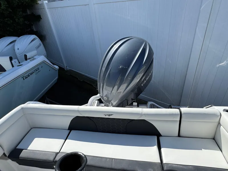 Slide: The Image of 2025 Tidewater 232 LXF boat with sleek outboard motor and comfortable seating. - 6