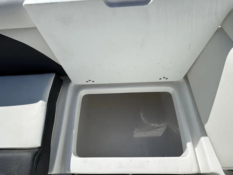 Slide: The Image of Open storage compartment on 2025 Tidewater 232 LXF boat, featuring a sleek design. - 7