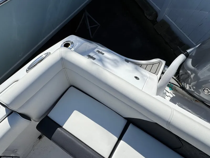 Slide: The Image of 2025 Tidewater 232 LXF boat interior with white seating and cup holder. - 8