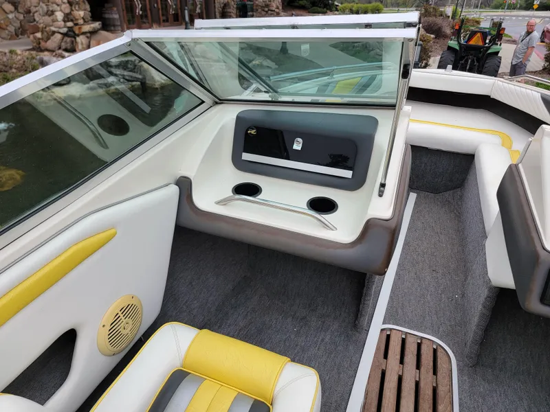 Slide: The Image of Interior of a 1990 Sea Ray 200 BR boat with yellow and white seating. - 12