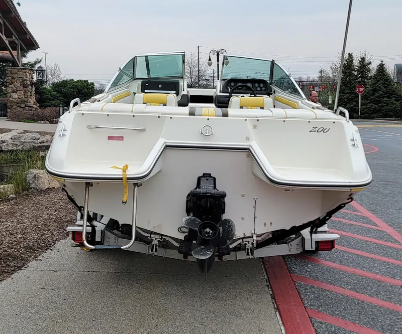 Slide: The Image of 1990 Sea Ray 200 BR boat on trailer, rear view, parked outdoors. - 3