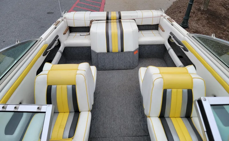 Slide: The Image of 1990 Sea Ray 200 BR boat interior with yellow, white, and gray striped seating. - 7