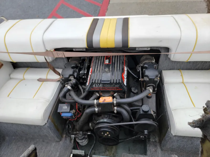 Slide: The Image of Engine of a 1990 Sea Ray 200 BR boat, showcasing detailed components and seating. - 9