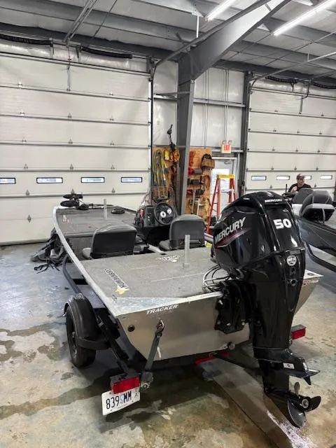 Slide: The Image of 2019 Bass Tracker Classic boat with Mercury 50 engine in a garage setting. - 6