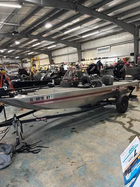 Slide: The Image of 2019 Bass Tracker Classic boat displayed in a showroom with other boats. - 9