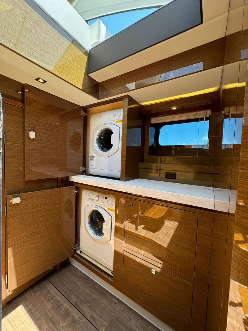 Slide: The Image of 2021 Cruisers Yachts 60 Cantius laundry area with stacked washer and dryer. - 15