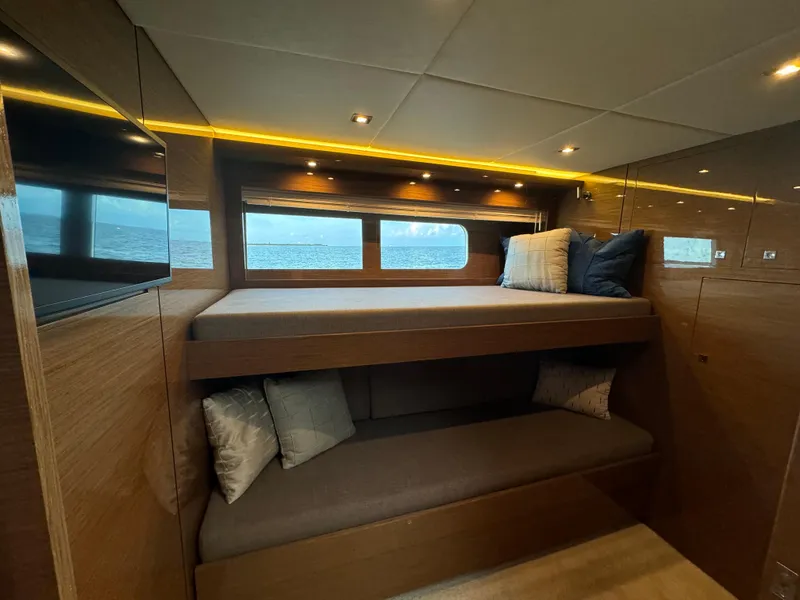 Slide: The Image of Luxurious 2021 Cruisers Yachts 60 Cantius cabin with bunk beds and elegant lighting. - 18