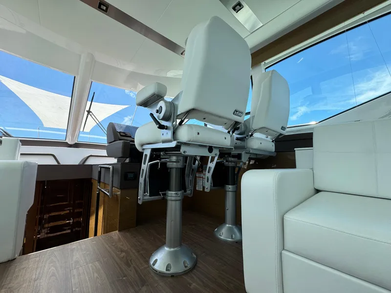 Slide: The Image of Interior of 2021 Cruisers Yachts 60 Cantius with modern seating and panoramic windows. - 22