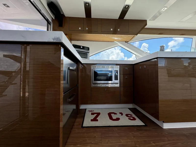 Slide: The Image of Luxurious kitchen interior of 2021 Cruisers Yachts 60 Cantius with modern appliances and sleek cabinetry. - 28