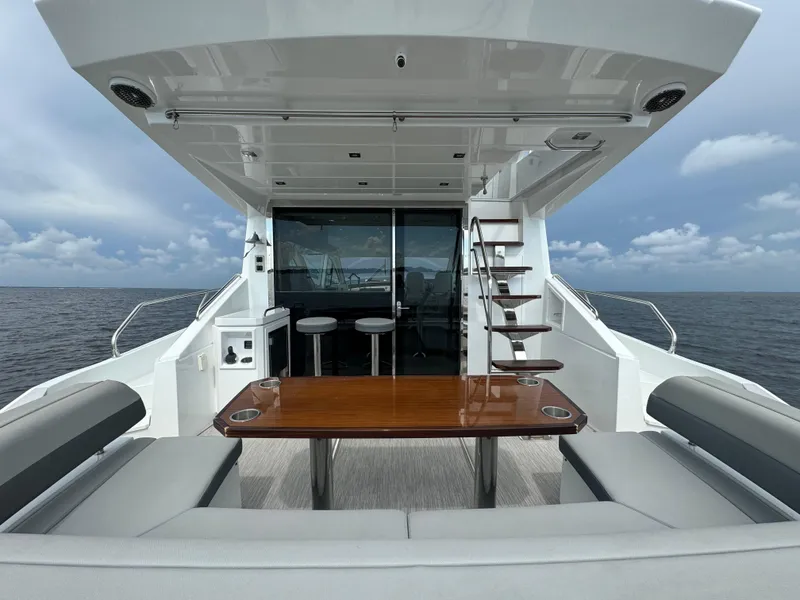Slide: The Image of 2021 Cruisers Yachts 60 Cantius, luxury yacht deck with seating and ocean view. - 32
