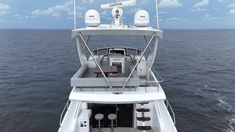 Slide: The Image of 2021 Cruisers Yachts 60 Cantius on open sea, showcasing upper deck and seating area. - 35