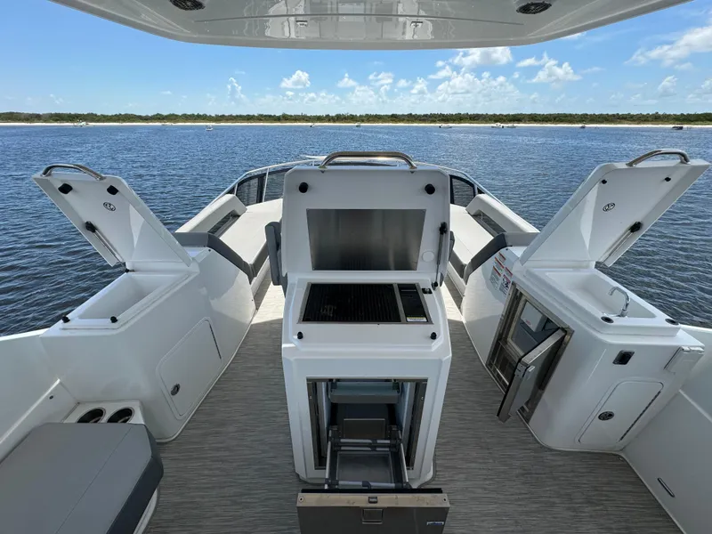 Slide: The Image of Luxurious 2021 Cruisers Yachts 60 Cantius deck with open storage, grill, and scenic water view. - 42