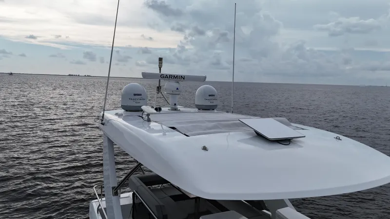 Slide: The Image of 2021 Cruisers Yachts 60 Cantius on open water, featuring advanced Garmin navigation equipment. - 43