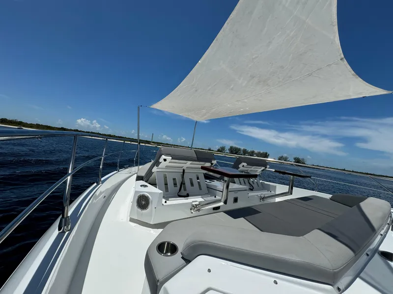 Slide: The Image of 2021 Cruisers Yachts 60 Cantius deck with seating and sunshade on open water. - 46