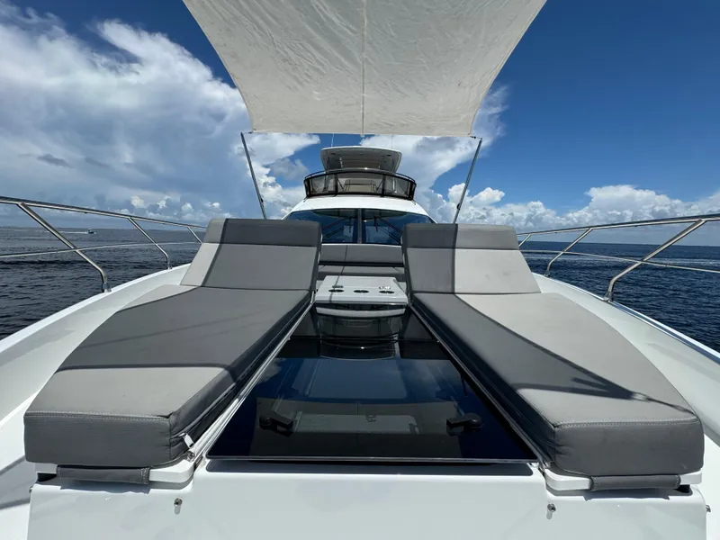 Slide: The Image of 2021 Cruisers Yachts 60 Cantius with sun loungers and canopy on open sea. - 47