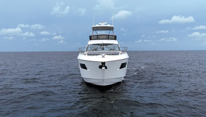 Slide: The Image of 2021 Cruisers Yachts 60 Cantius on open water under a cloudy sky. - 5