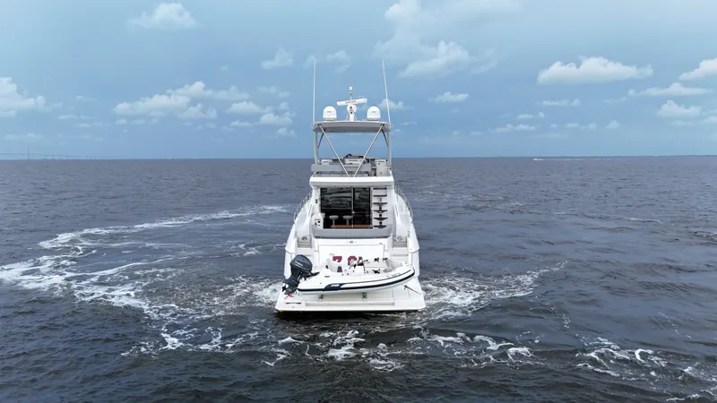 Slide: The Image of 2021 Cruisers Yachts 60 Cantius on open water under cloudy sky. - 9