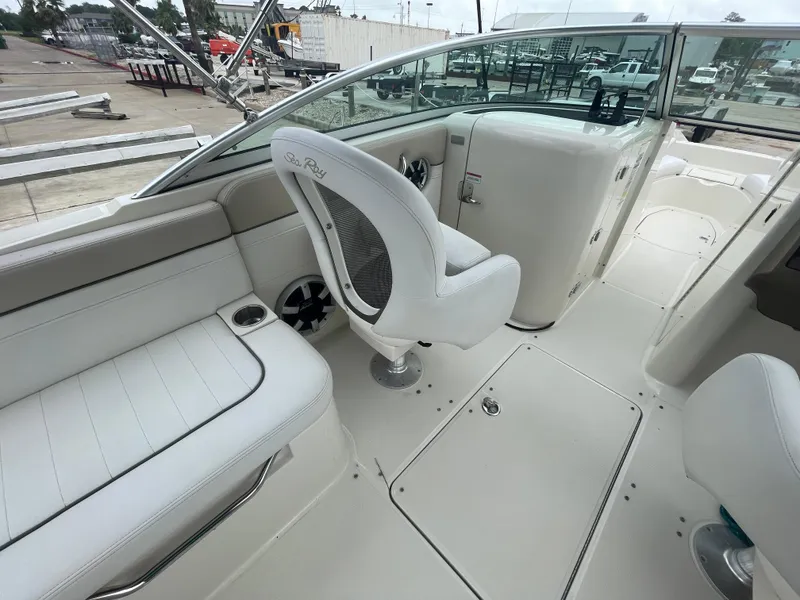 Slide: The Image of 2009 Sea Ray 260 Sundeck interior with white seating and helm. - 14