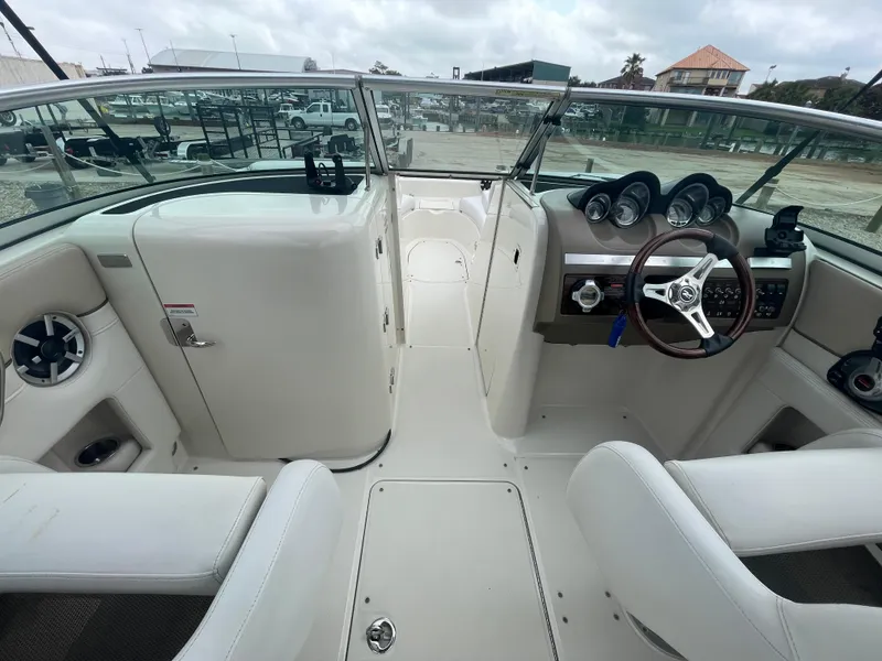 Slide: The Image of 2009 Sea Ray 260 Sundeck interior with steering wheel and seating, showcasing dashboard and controls. - 16