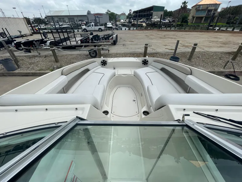 Slide: The Image of 2009 Sea Ray 260 Sundeck boat with spacious seating, docked at a marina. - 20