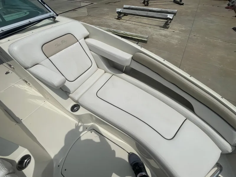 Slide: The Image of 2009 Sea Ray 260 Sundeck boat with white cushioned seating on deck. - 24
