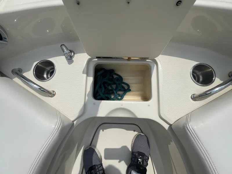 Slide: The Image of 2009 Sea Ray 260 Sundeck interior with storage compartment and cup holders. - 25