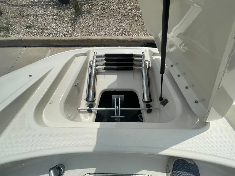 Slide: The Image of 2009 Sea Ray 260 Sundeck boat with open storage compartment and ladder. - 26