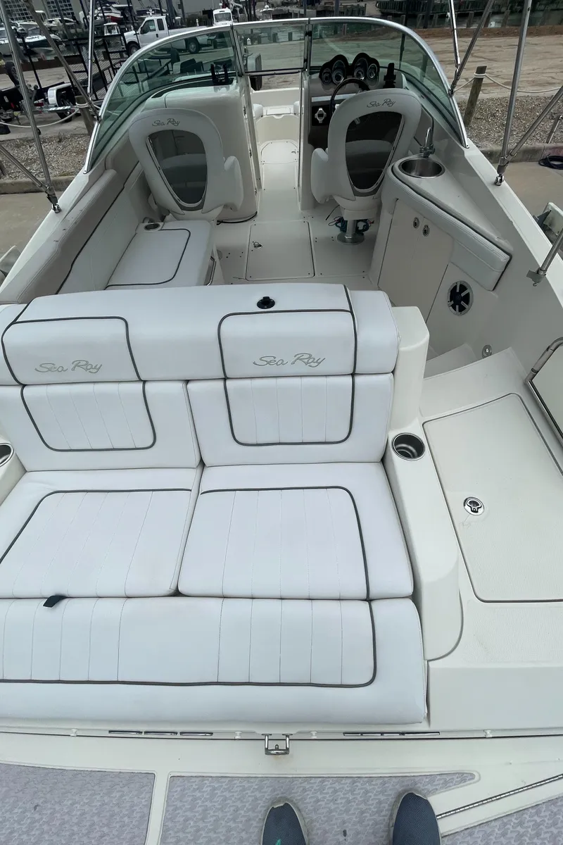 Slide: The Image of 2009 Sea Ray 260 Sundeck with spacious white seating and modern dashboard. - 33
