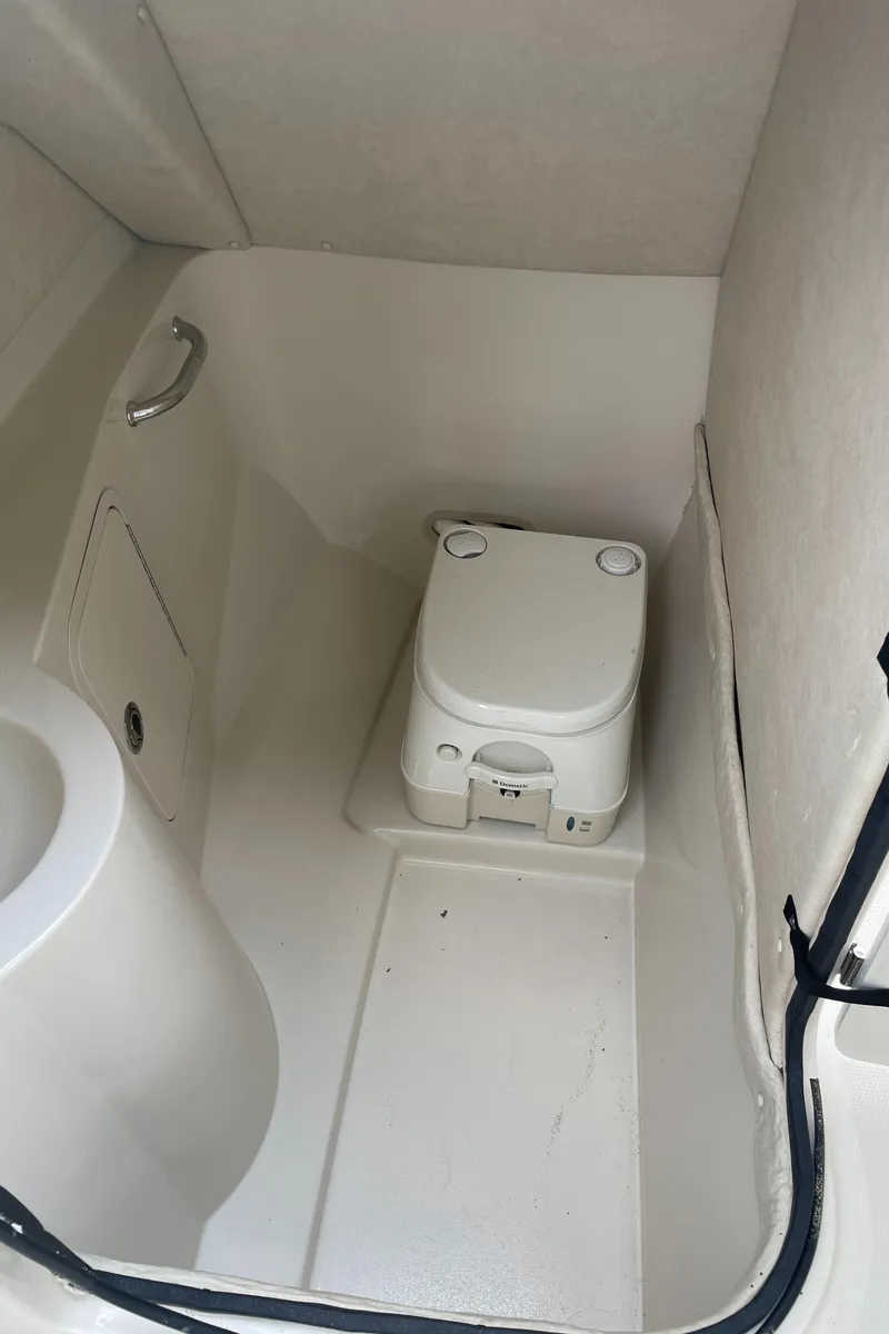 Slide: The Image of 2009 Sea Ray 260 Sundeck interior with compact marine toilet. - 34