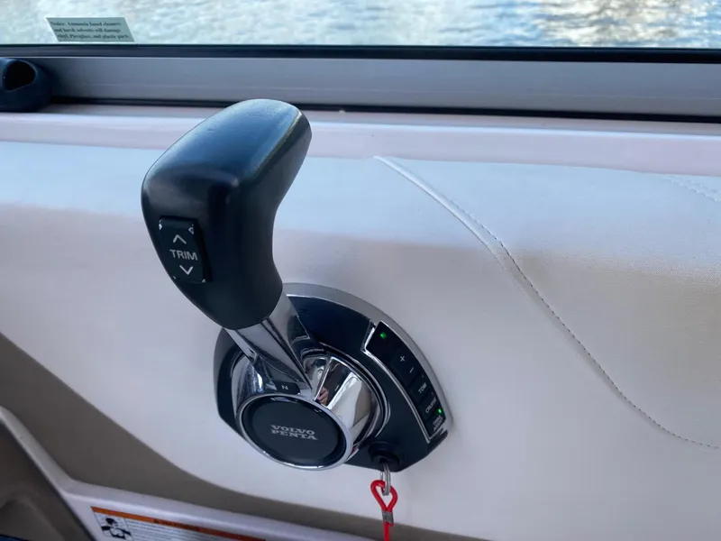 Slide: The Image of Throttle control lever on a 2019 Regal 26 Express boat interior. - 13