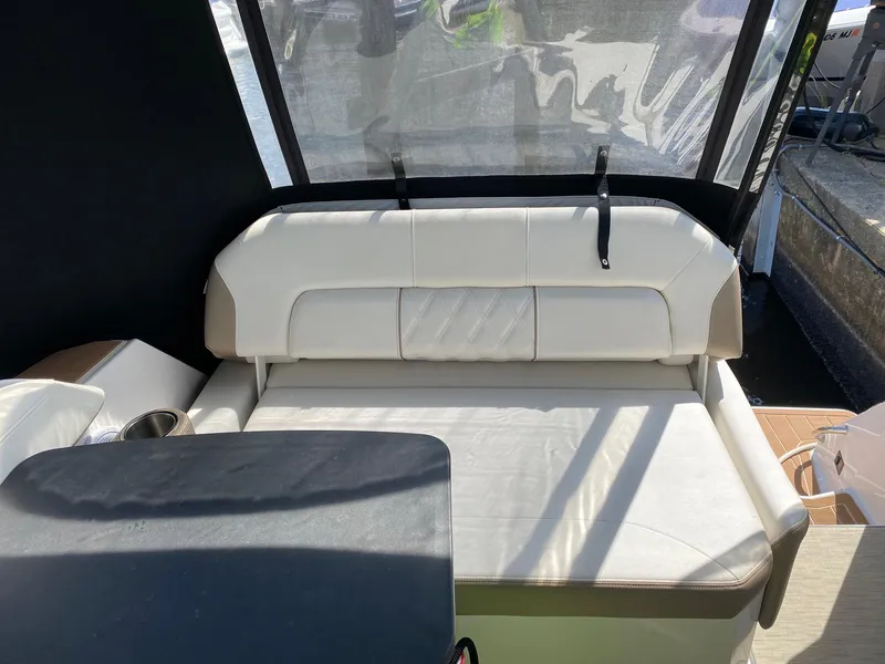 Slide: The Image of 2019 Regal 26 Express boat interior with cushioned seating and table. - 14