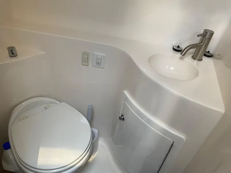 Slide: The Image of Compact bathroom in 2019 Regal 26 Express boat with toilet and sink. - 16