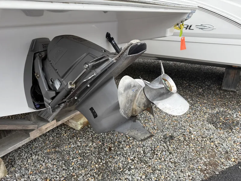 Slide: The Image of 2019 Regal 26 Express boat propeller and stern drive on gravel surface. - 17