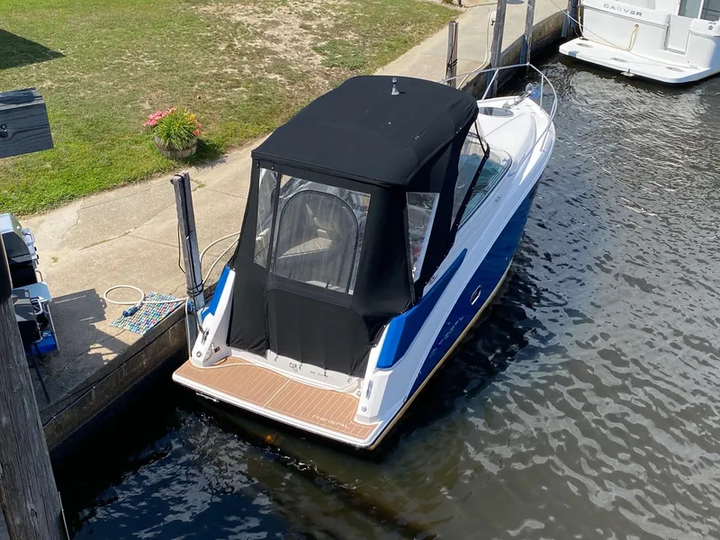 Slide: The Image of 2019 Regal 26 Express boat docked in a marina, featuring a black canopy. - 5
