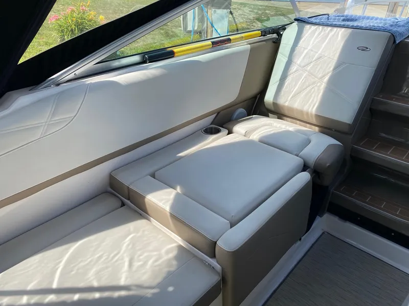 Slide: The Image of 2019 Regal 26 Express boat interior with beige seating and cup holder. - 6
